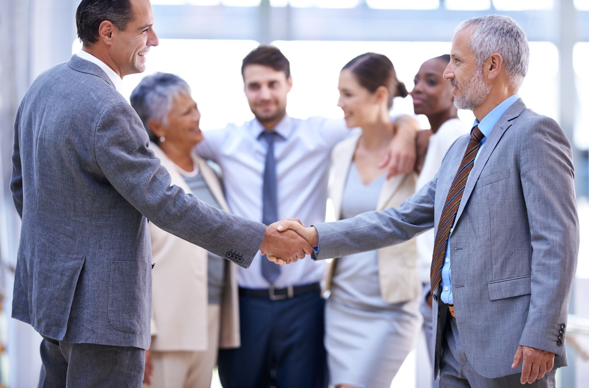 A group of business people shaking hands with each other