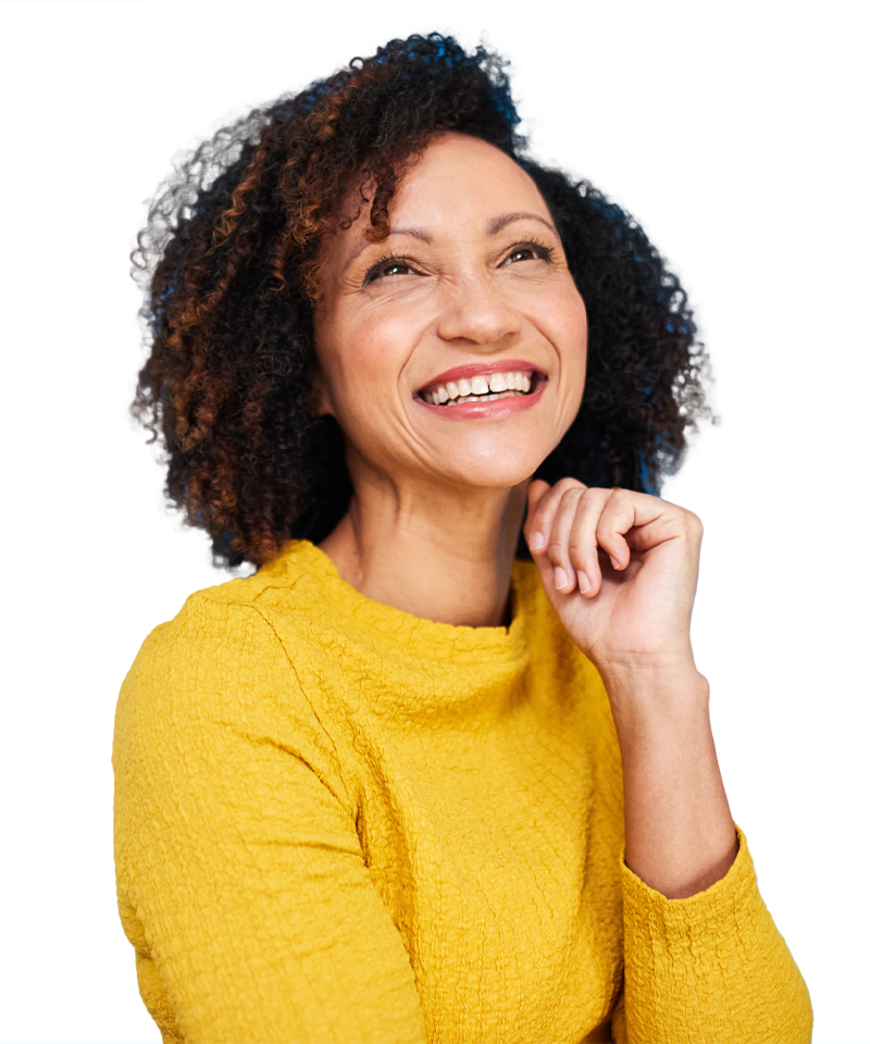 A woman in a yellow sweater is smiling and looking up.