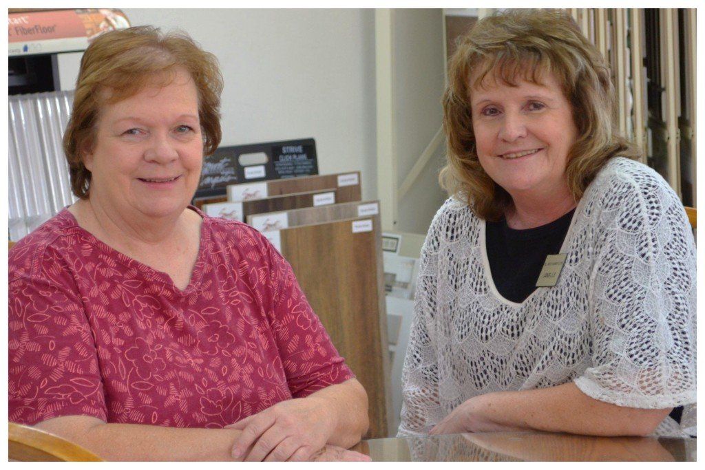 Owners of Mock Fashion Floors Janelle & Joyce work at store front