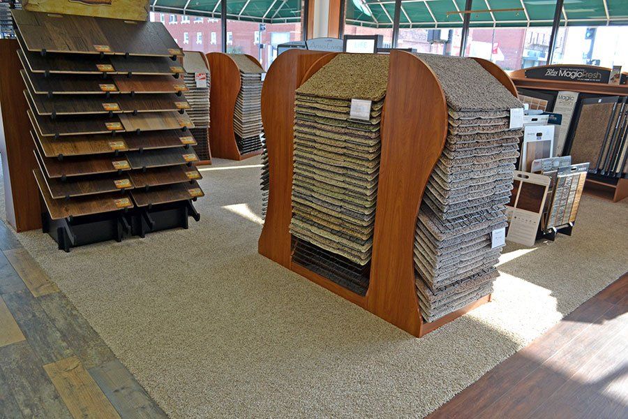 Mock Fashion Floors gallery, shelves displaying hardwood, carpet & tile