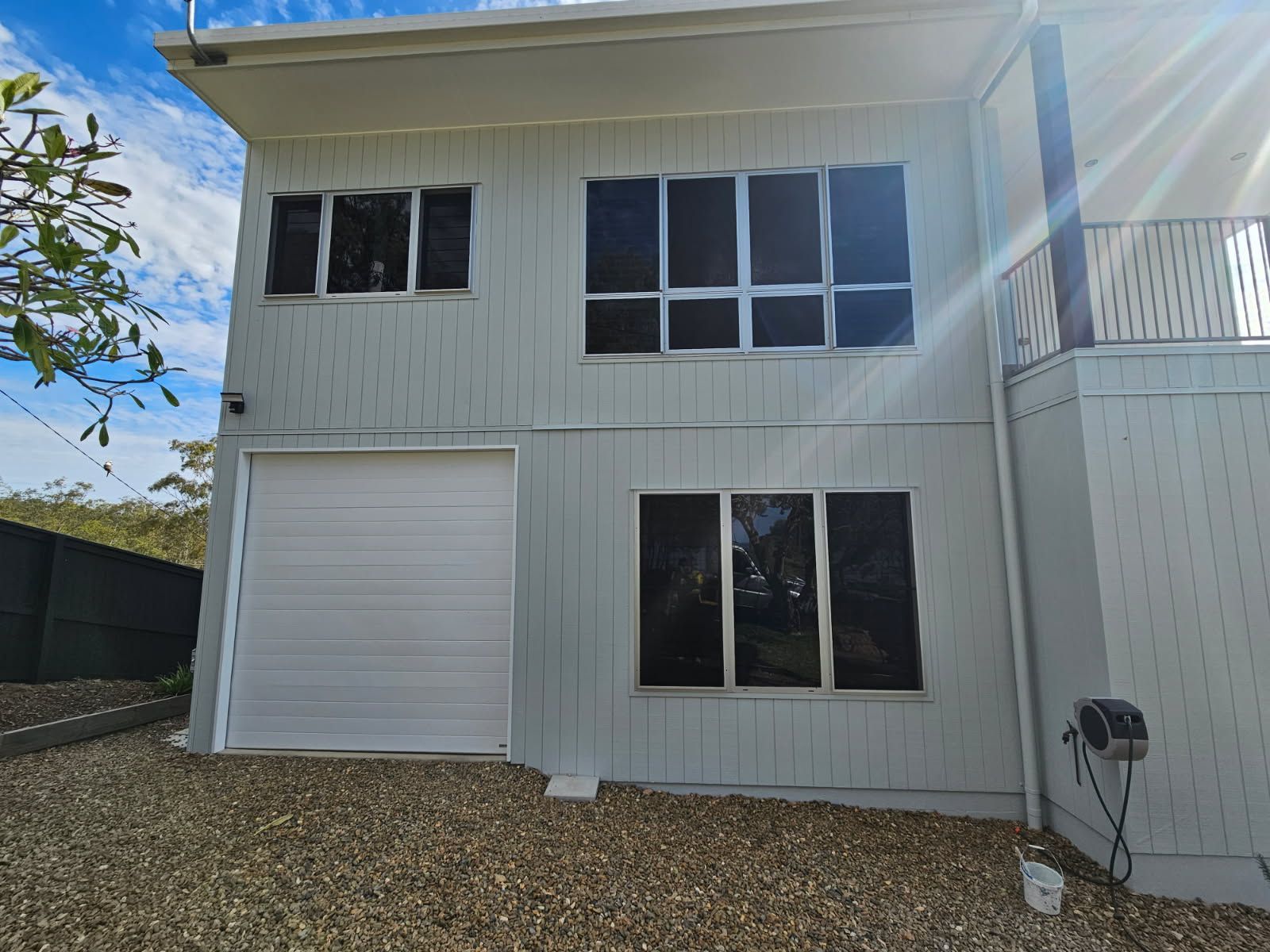 A Two-story House With Gray Vertical Siding — Priority Painters in Gladstone Central, QLD