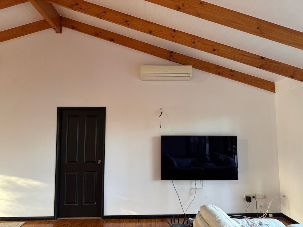 A Living Room With a Vaulted Ceiling, Exposed Wood Beams — Priority Painters in Gladstone Central, QLD