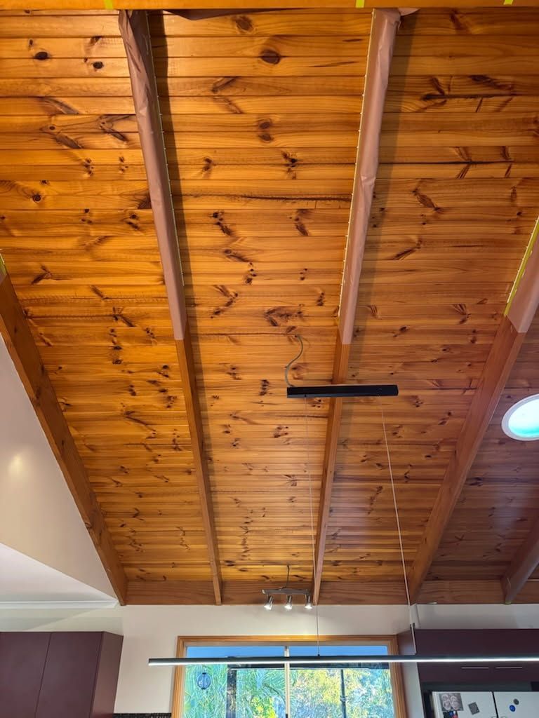 A Vaulted Wooden Ceiling With Exposed Beams — Priority Painters in Gladstone Central, QLD