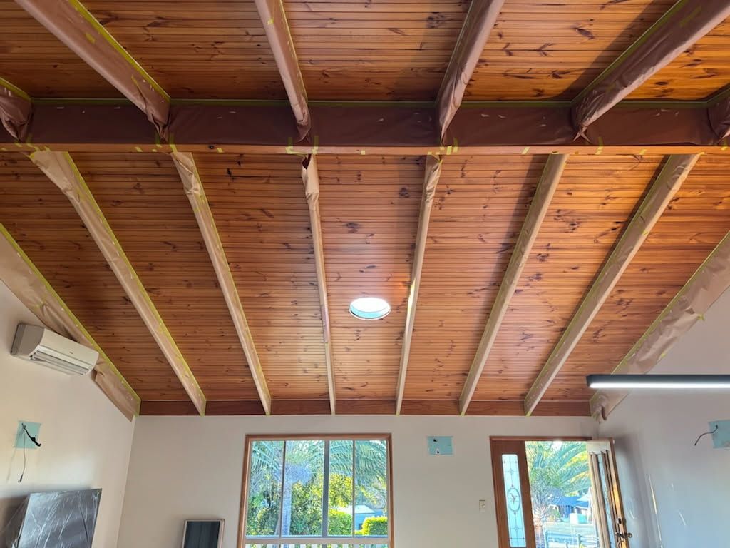 A Room With High, Vaulted Ceilings Featuring Exposed Wooden Beams — Priority Painters in Gladstone Central, QLD