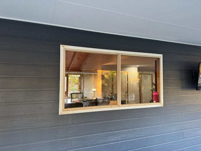A Rectangular Window With a Light-colored Wooden Frame — Priority Painters in Gladstone Central, QLD