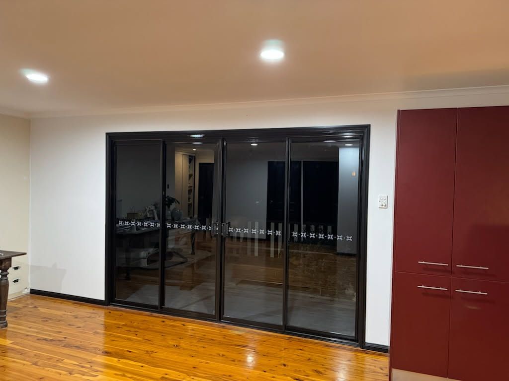 A Room With Glossy Wooden Floors, White Walls — Priority Painters in Gladstone Central, QLD