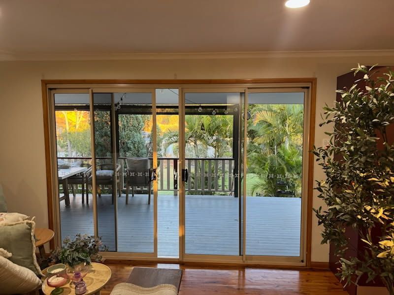Large Glass Sliding Doors Open Onto a Covered Wooden Deck — Priority Painters in Gladstone Central, QLD