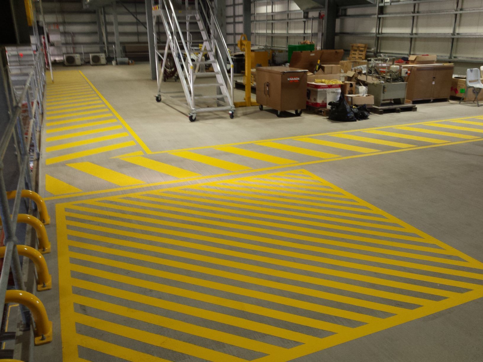 Industrial Warehouse Floor With Yellow-striped Safety Markings — Priority Painters in Gladstone Central, QLD