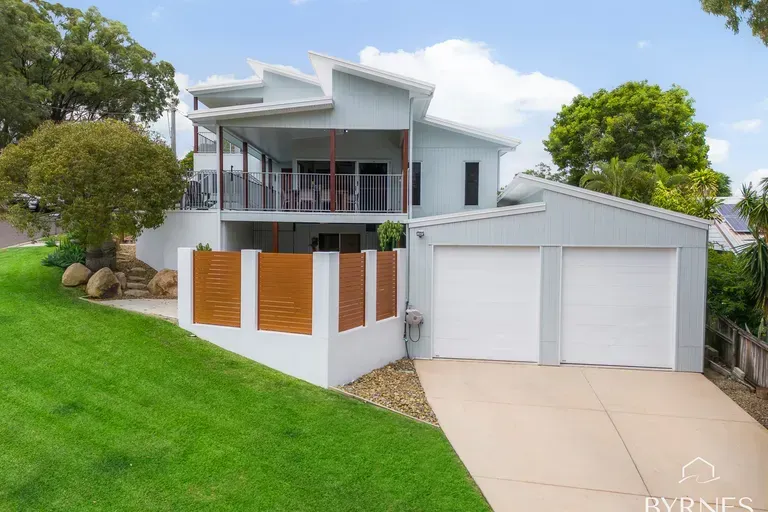 A Two-story Light Blue Suburban Home Featuring an Upper-level Balcony — Priority Painters in Gladstone Central, QLD