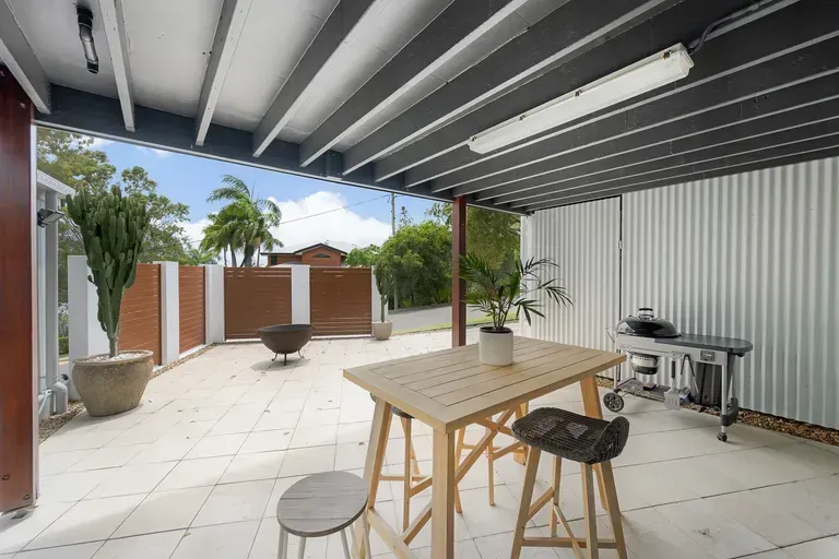 A Covered Outdoor Patio Featuring a White Tiled Flooring — Priority Painters in Gladstone Central, QLD