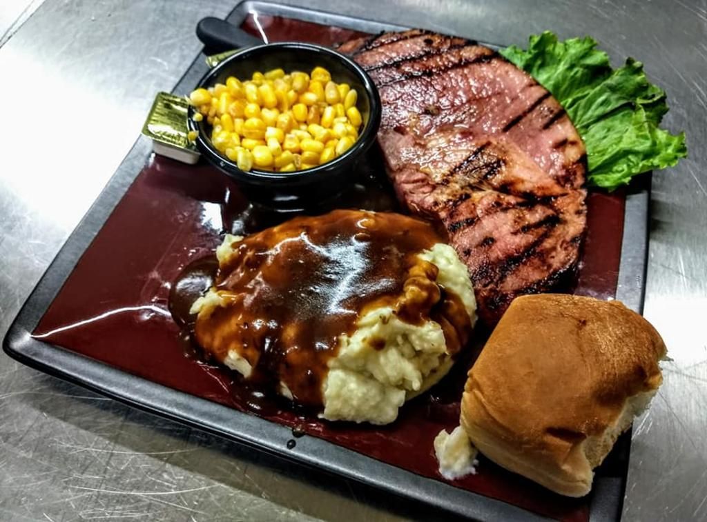a plate of food with mashed potatoes and corn on the cob