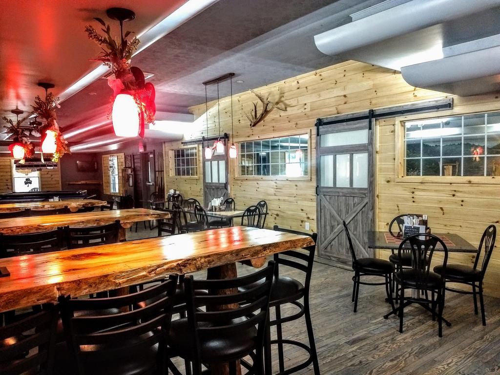 a restaurant with tables and chairs and a sliding barn door