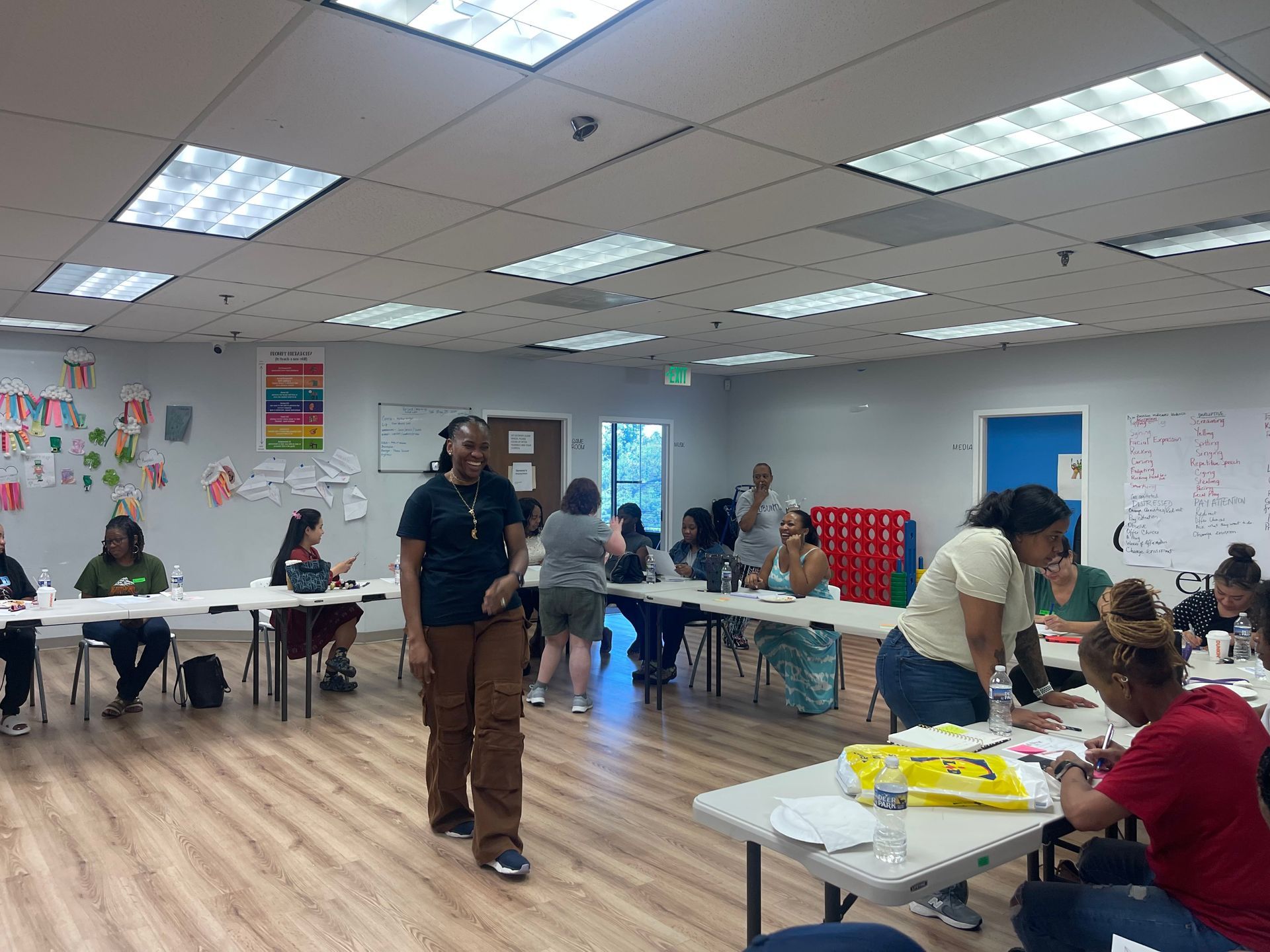 People walking together outdoors, some wearing red and yellow shirts.
