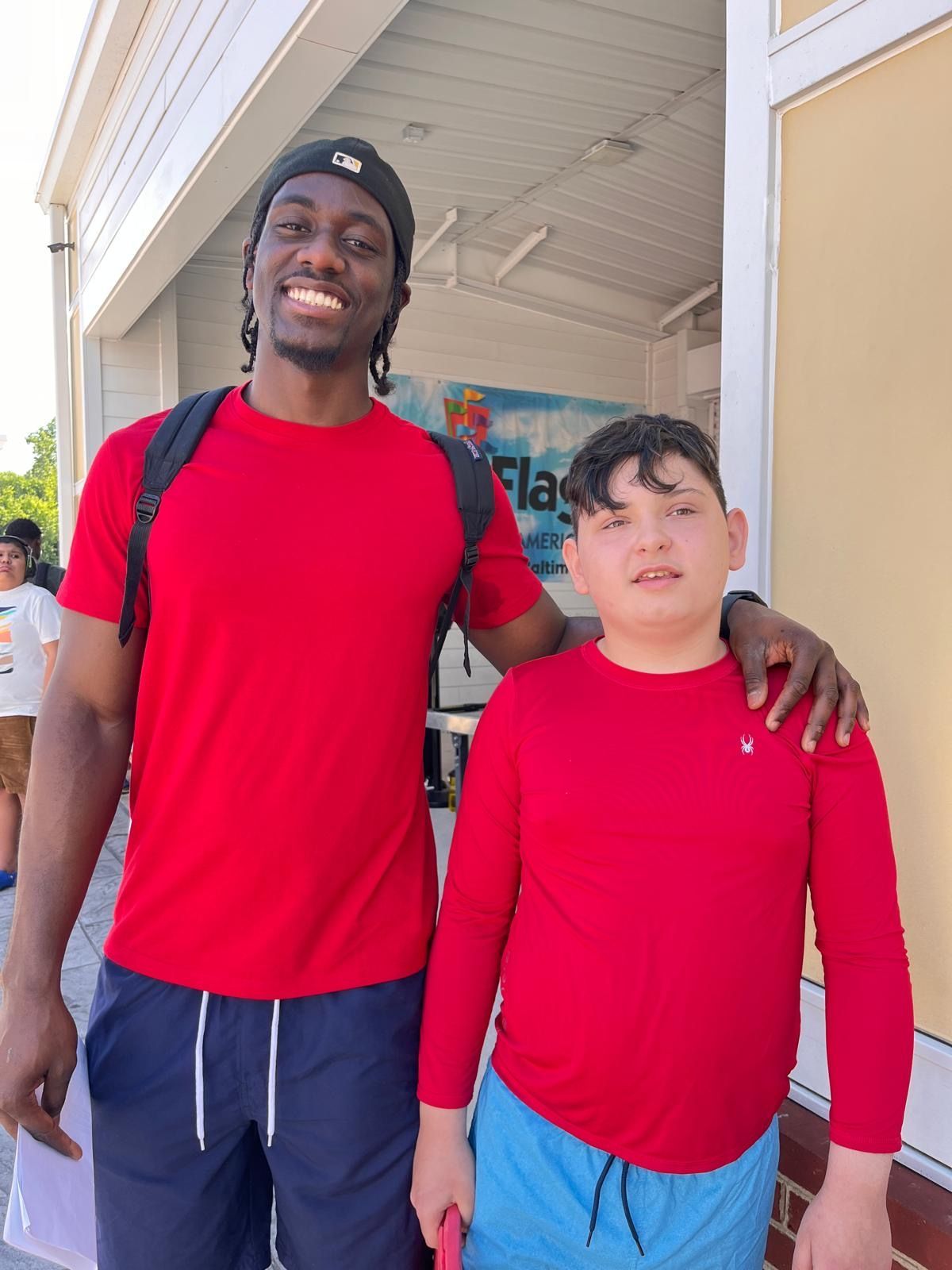 Child wearing eye mask in a store, holding up hands. 