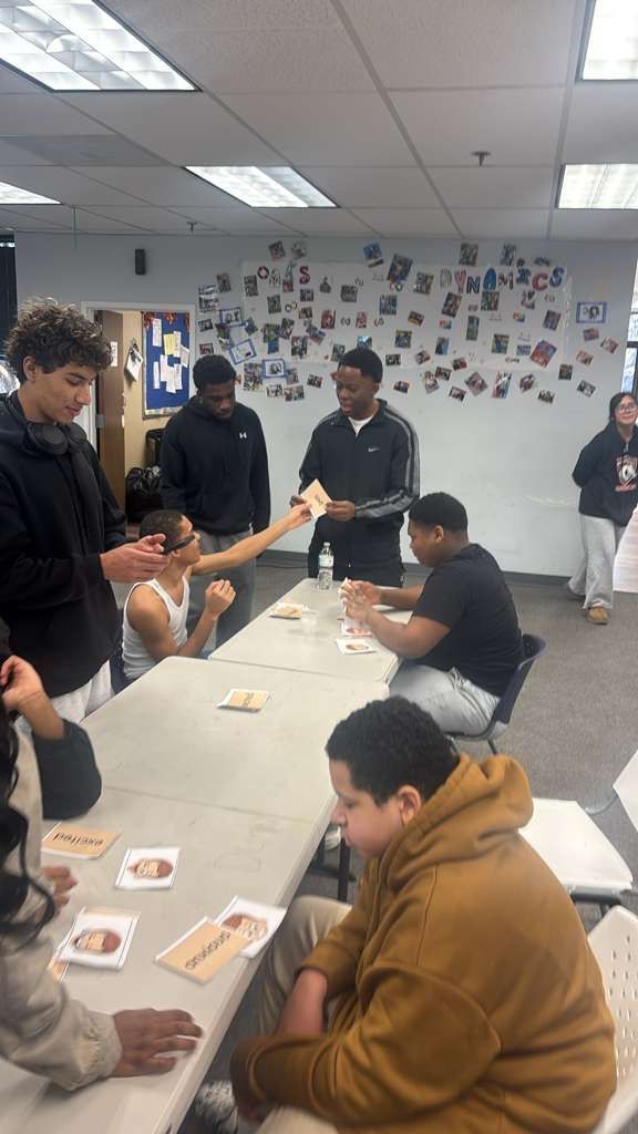 People walking together outdoors, some wearing red and yellow shirts.