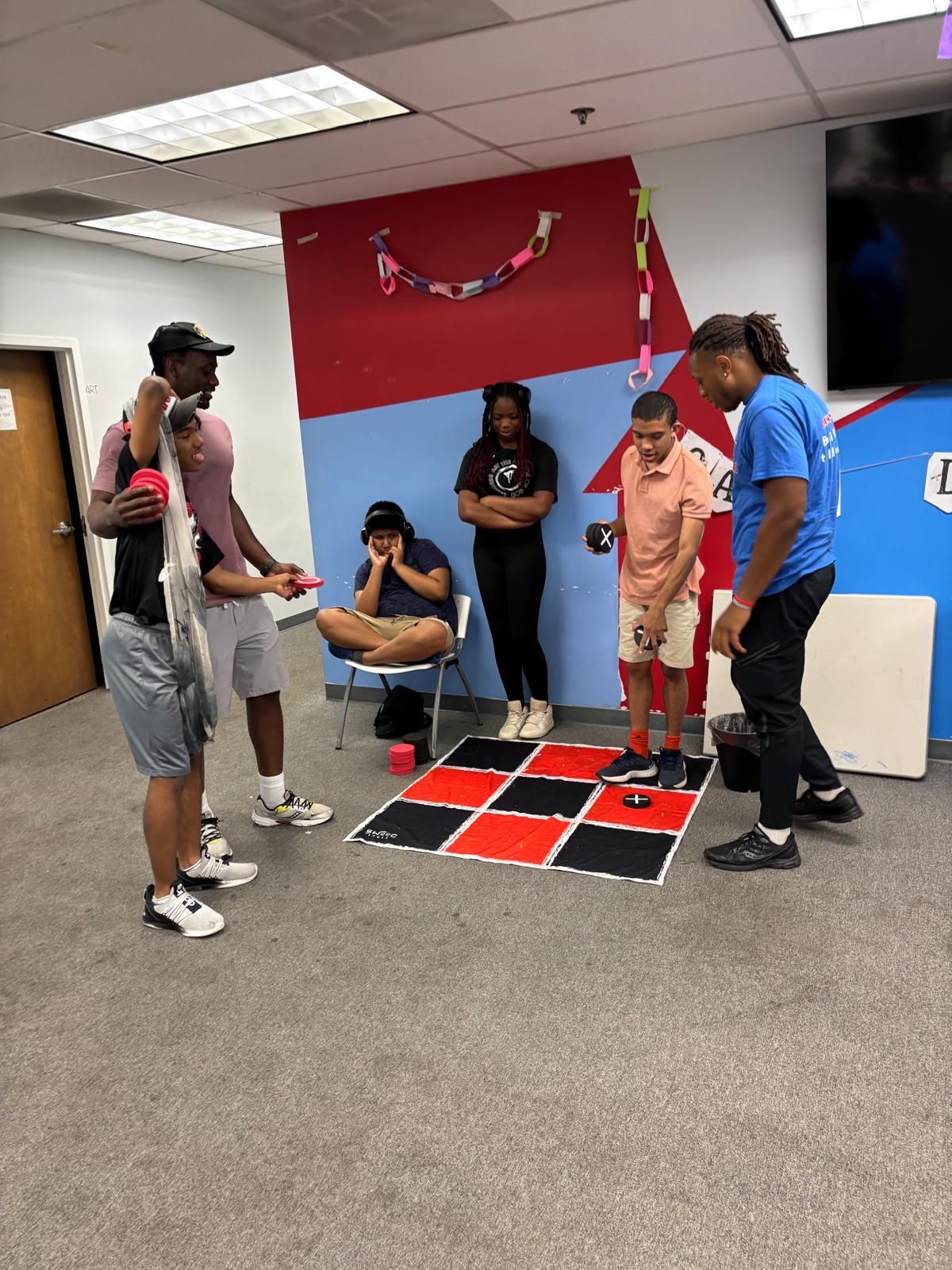 People playing a game on a checkerboard. 