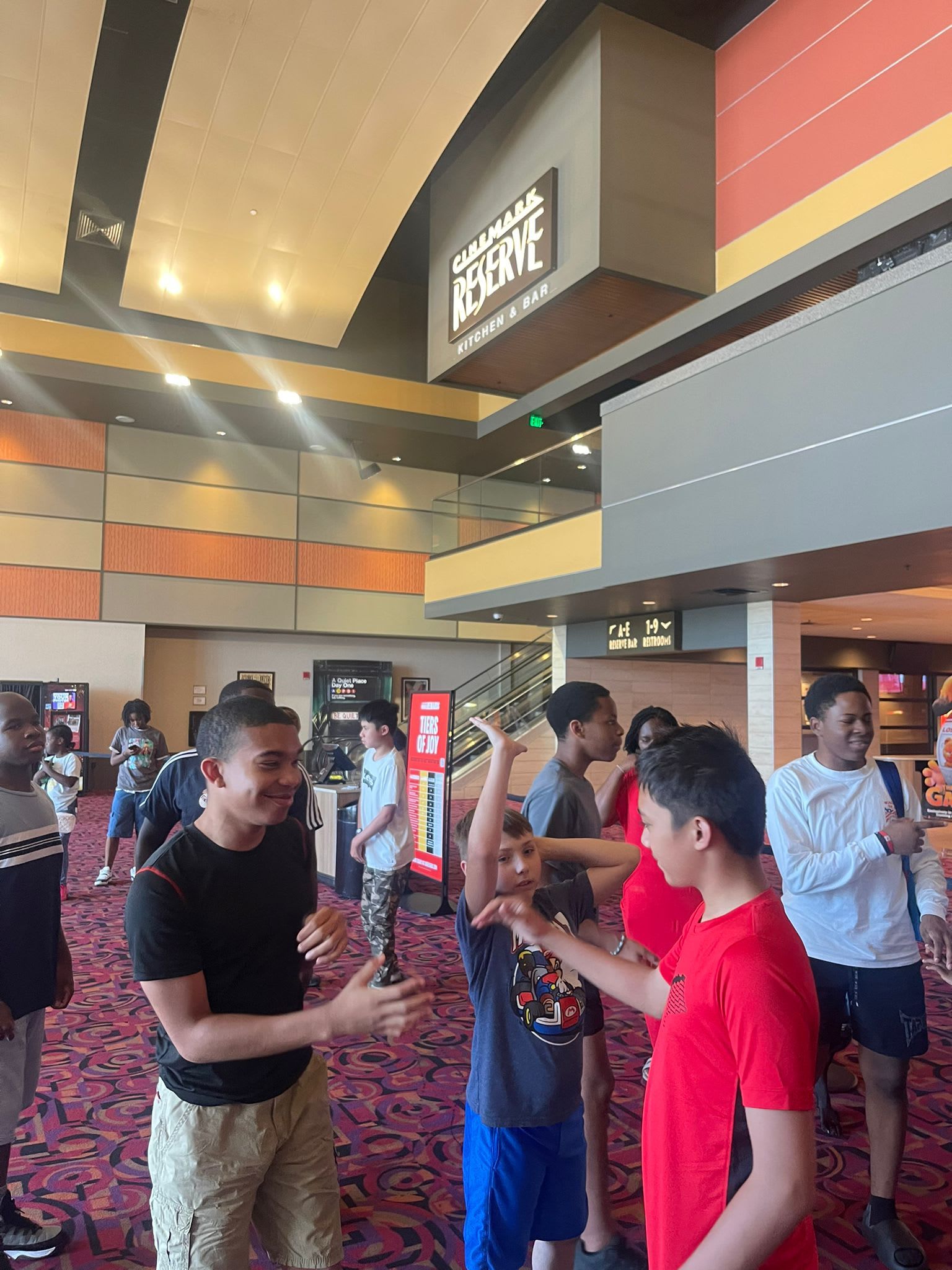 People inside a movie theater lobby. 