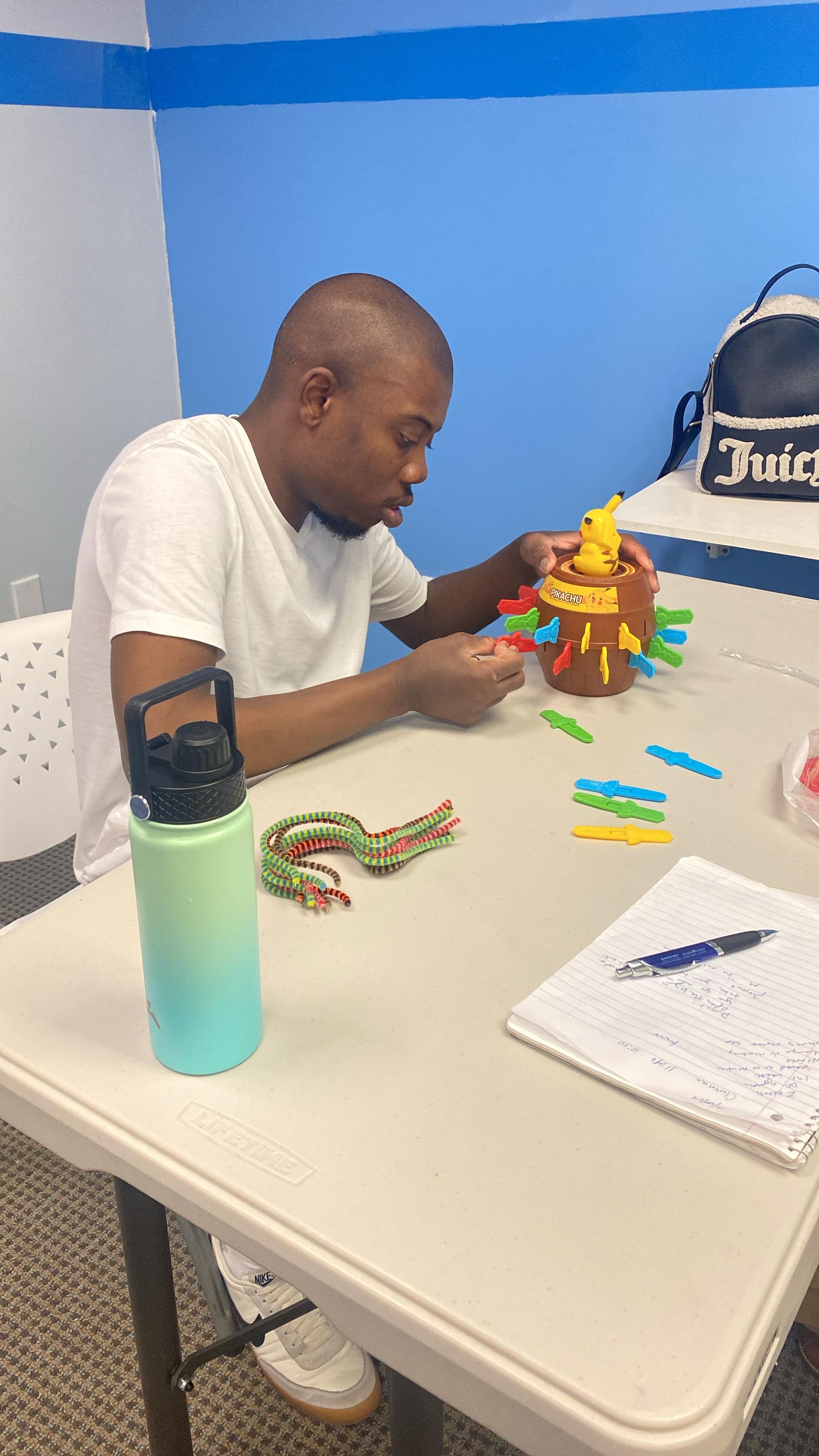 Man playing a game at a table. 