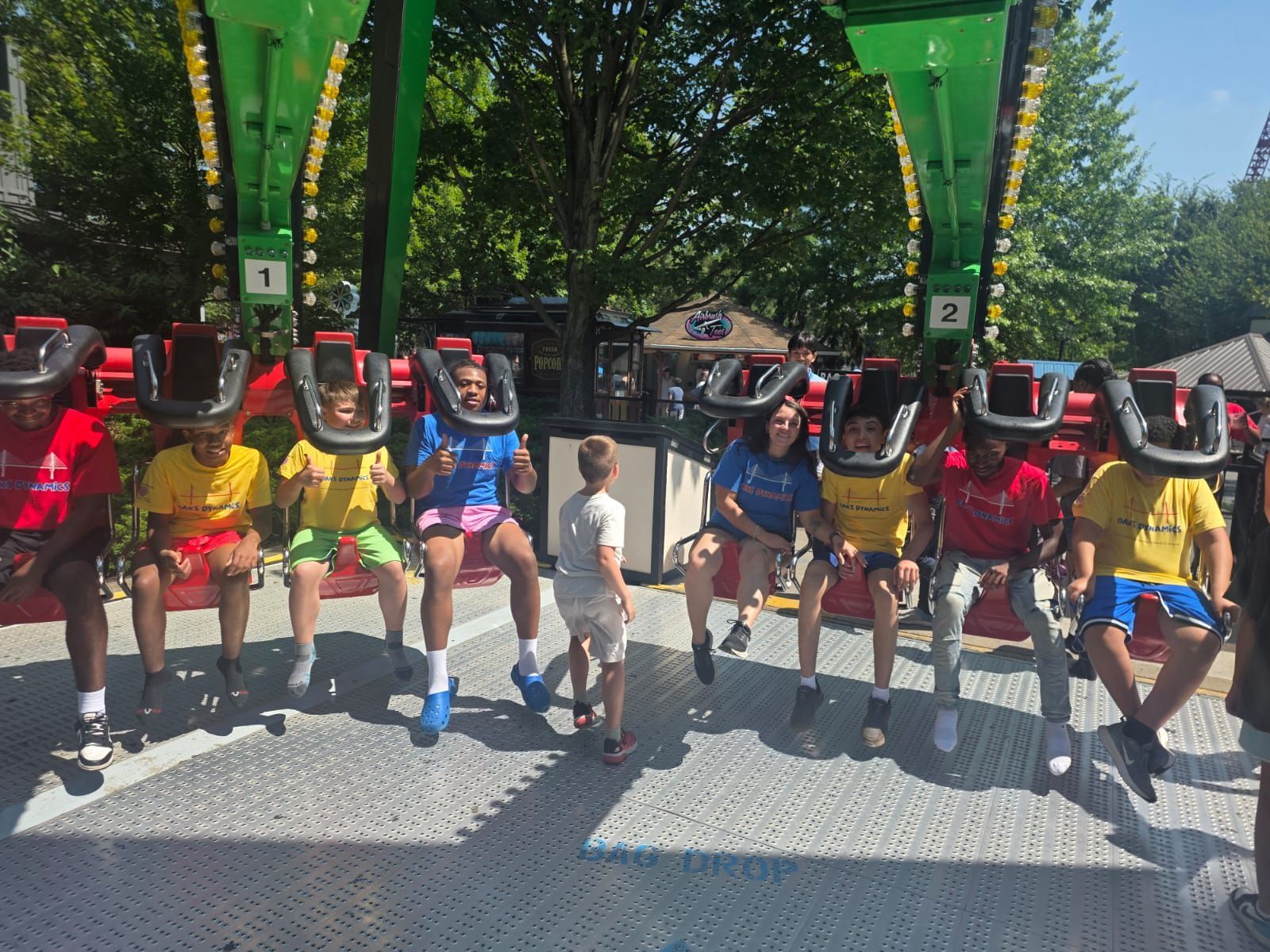 People on a carnival ride with safety restraints. 
