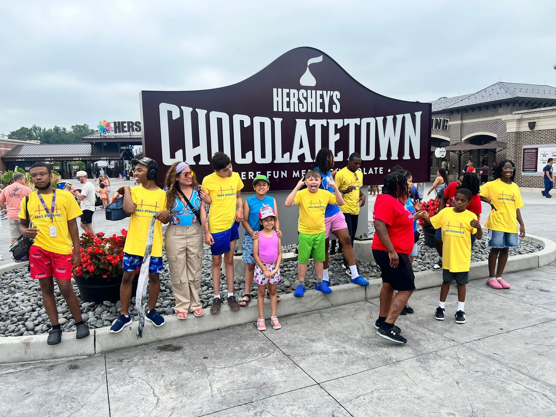 Group of people pose in front of Hershey's ChoclateTown sign. 