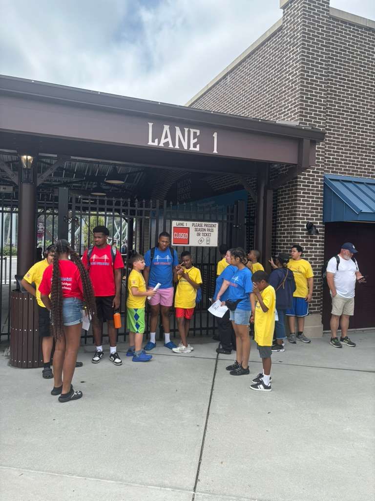 A group of people waits at 