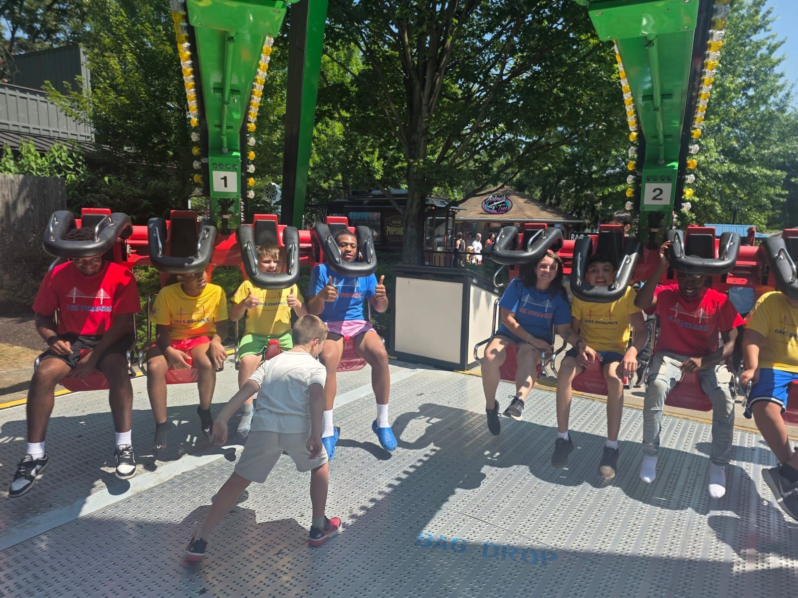 People on a theme park ride with restraints.