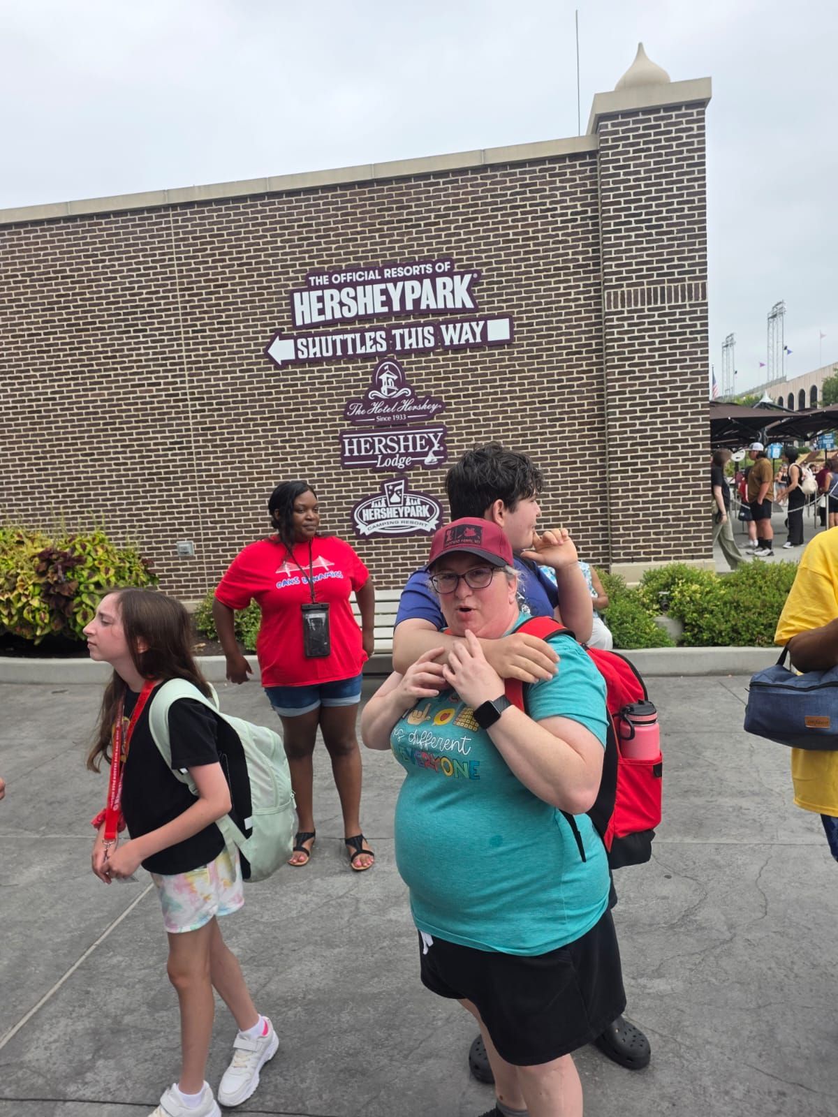 People near Hershey Park sign.