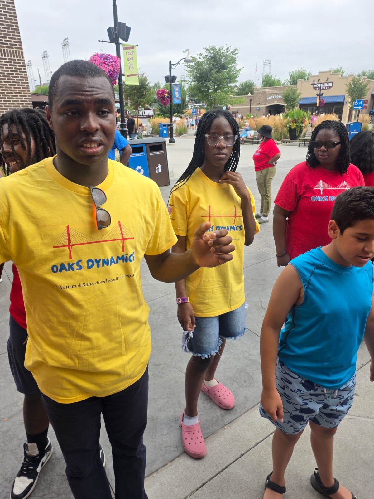 Group of people in yellow shirts, standing outdoors.