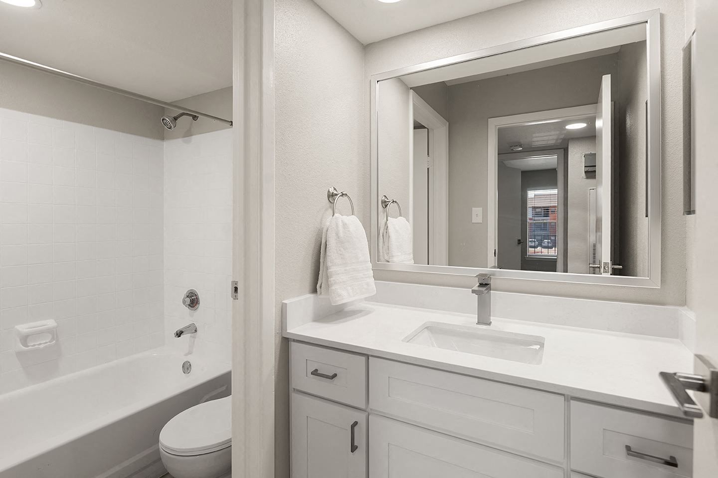 Modern bathroom with a tub, sink, and mirror