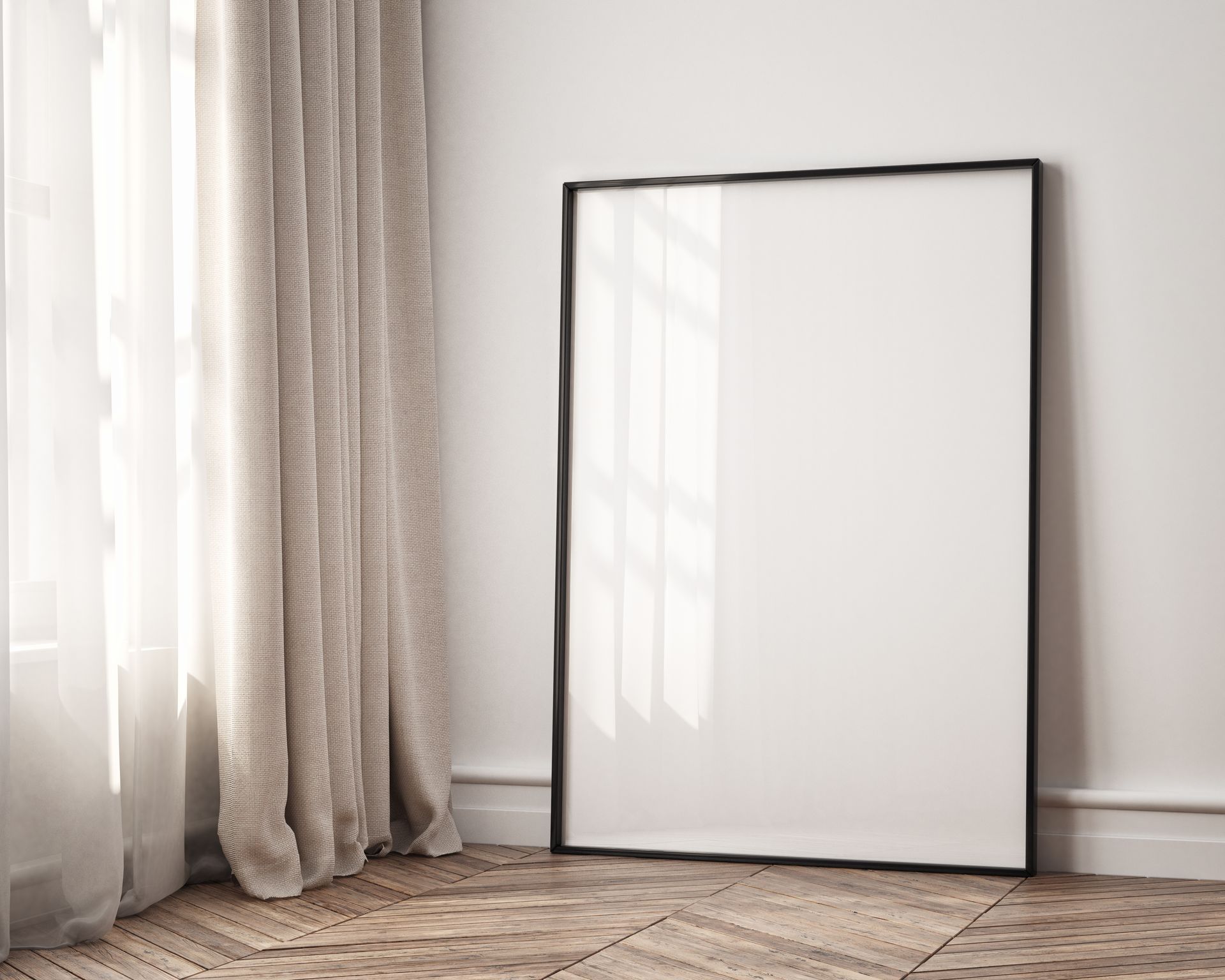 Empty black framed poster leaning against a white wall by a window with sheer curtains. Wooden floor.