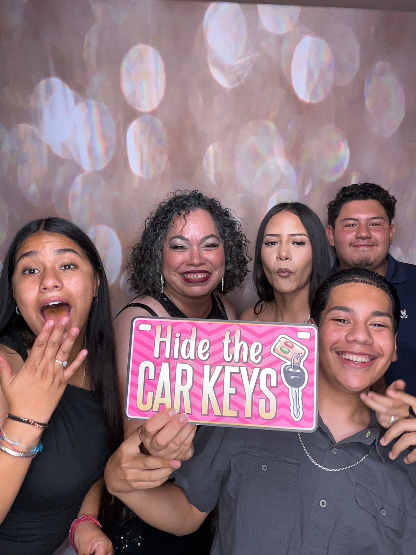 Guests laughing and posing during Tiffany's Sweet 16 photo booth experience in Perris, CA