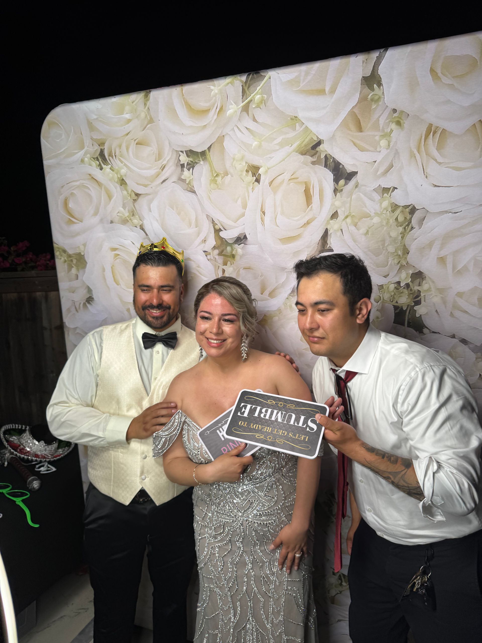 Bride and groom enjoying a backyard wedding photo booth in Moreno Valley, CA