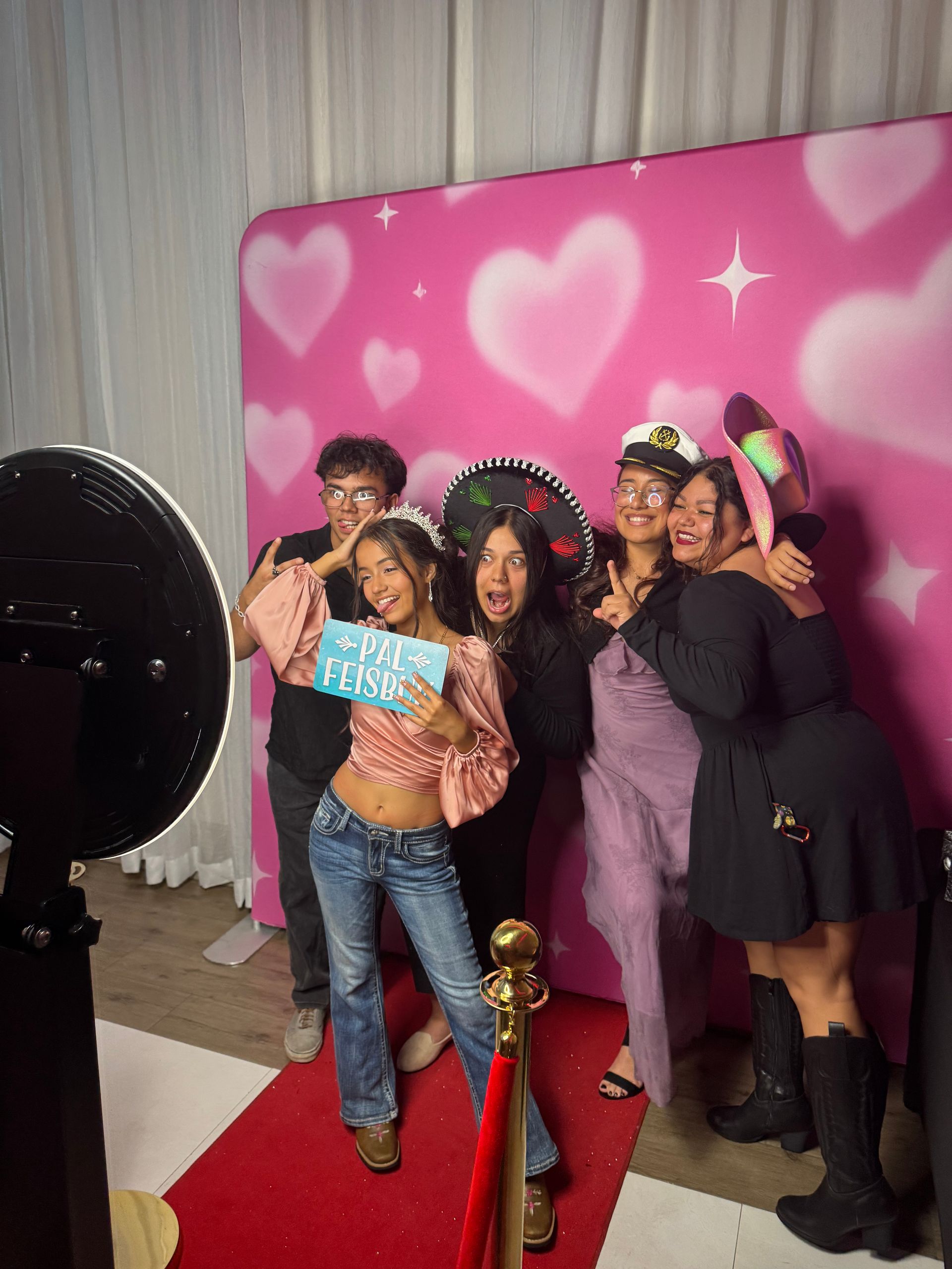 Guests posing with fun props at Brightlight Photo Booth during Elliany's quinceañera in Moreno Valley, CA