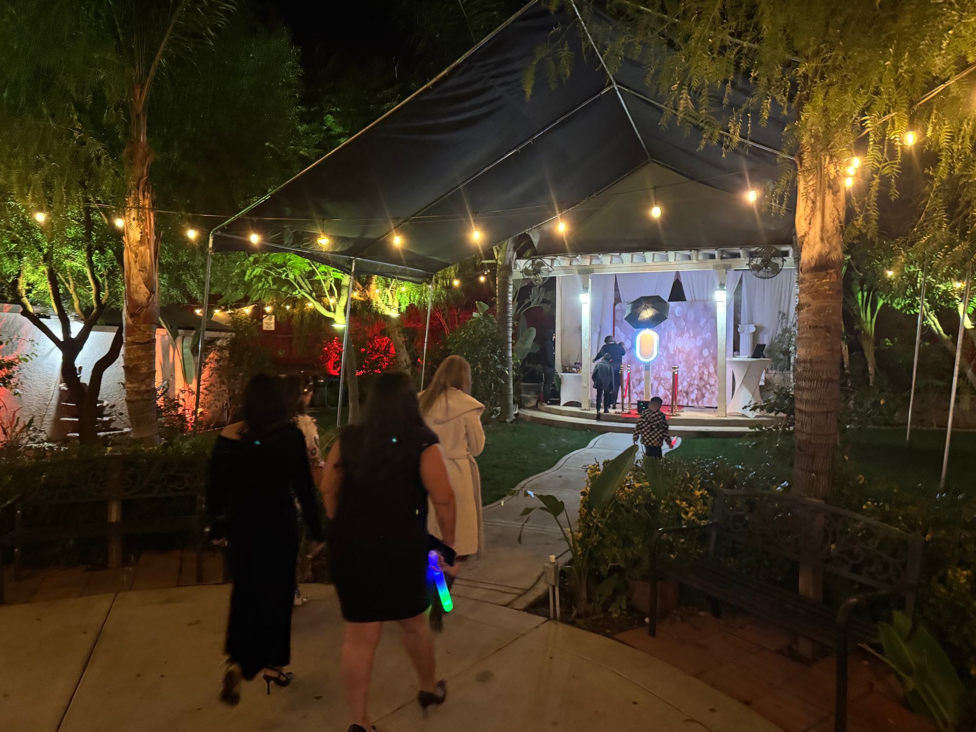 Guests walking toward the Brightlight Photo Booth at a quinceañera at Rancho Las Palmas in Perris, C