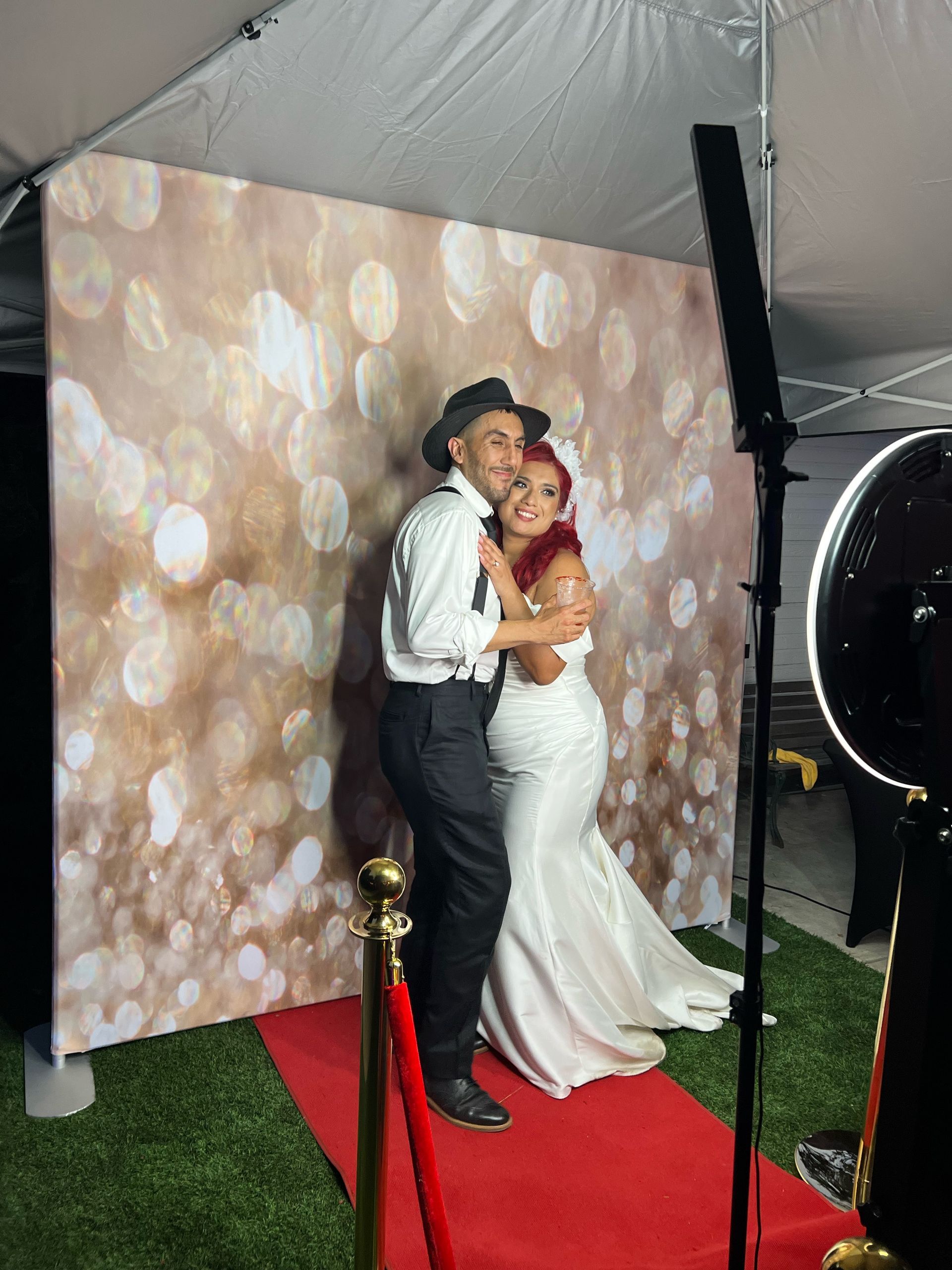 Bride and groom enjoying the Brightlight Photo Booth at Thatcher Manor Weddings in Gavilan Hills, California