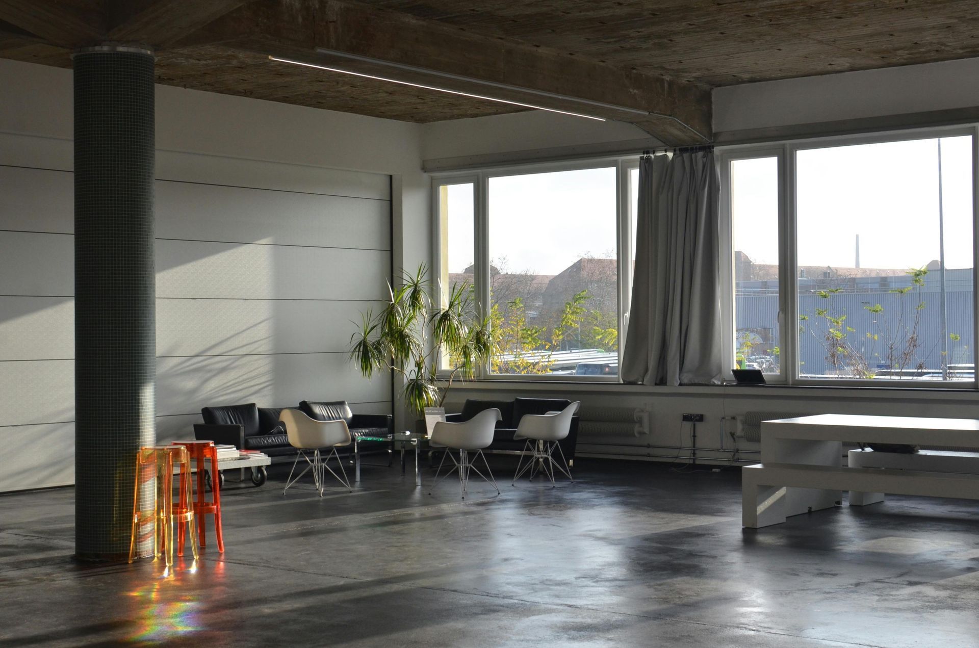 A large room with a lot of windows and furniture