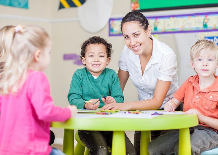 Child Care — Woman Taking Care Of Children At School In Idaho Falls, ID