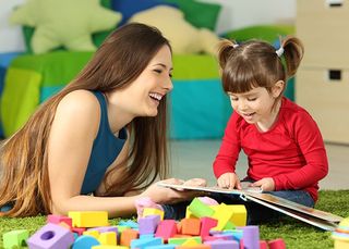Toddler Care — Woman And Toddler Playing With A Book In Idaho Falls, ID