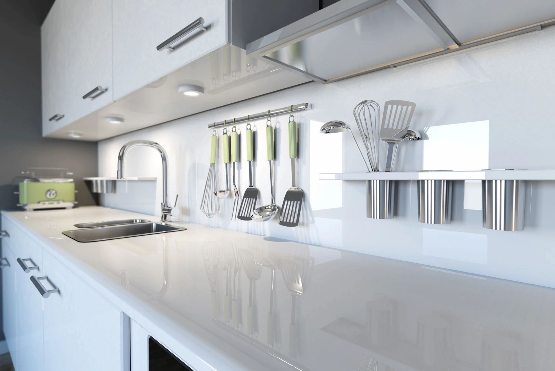 Modern white kitchen with stainless steel appliances, sink, and utensils.