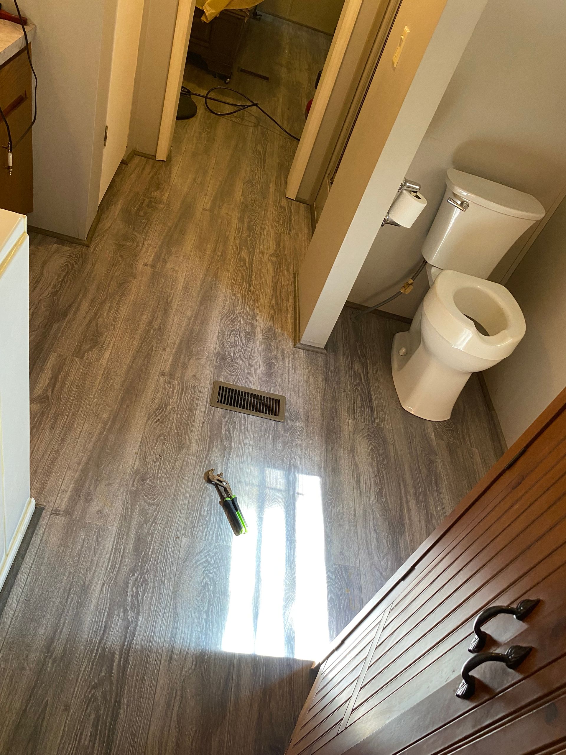 A bathroom with a toilet , sink and shower.