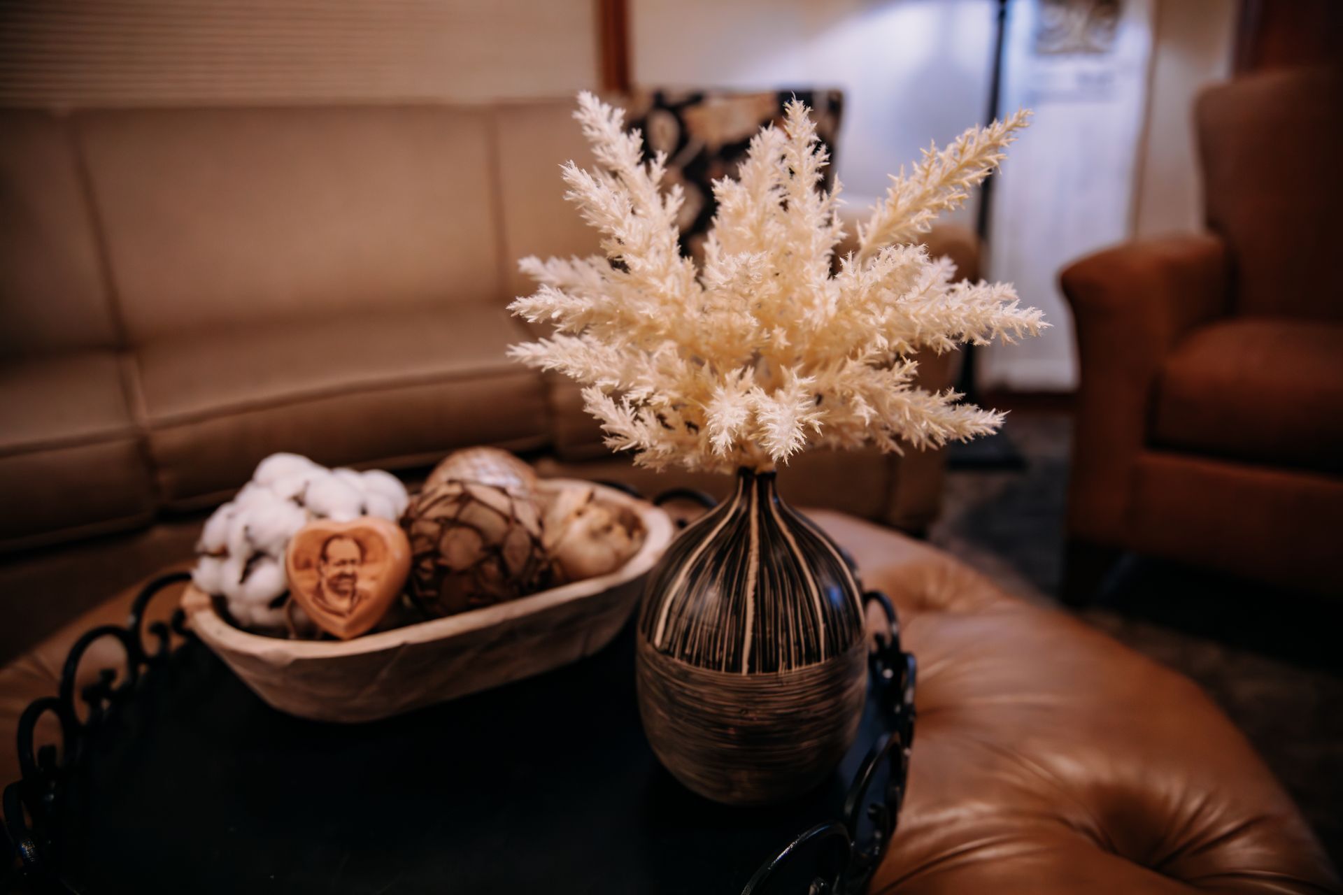 There are many different types of urns on display on a glass shelf.