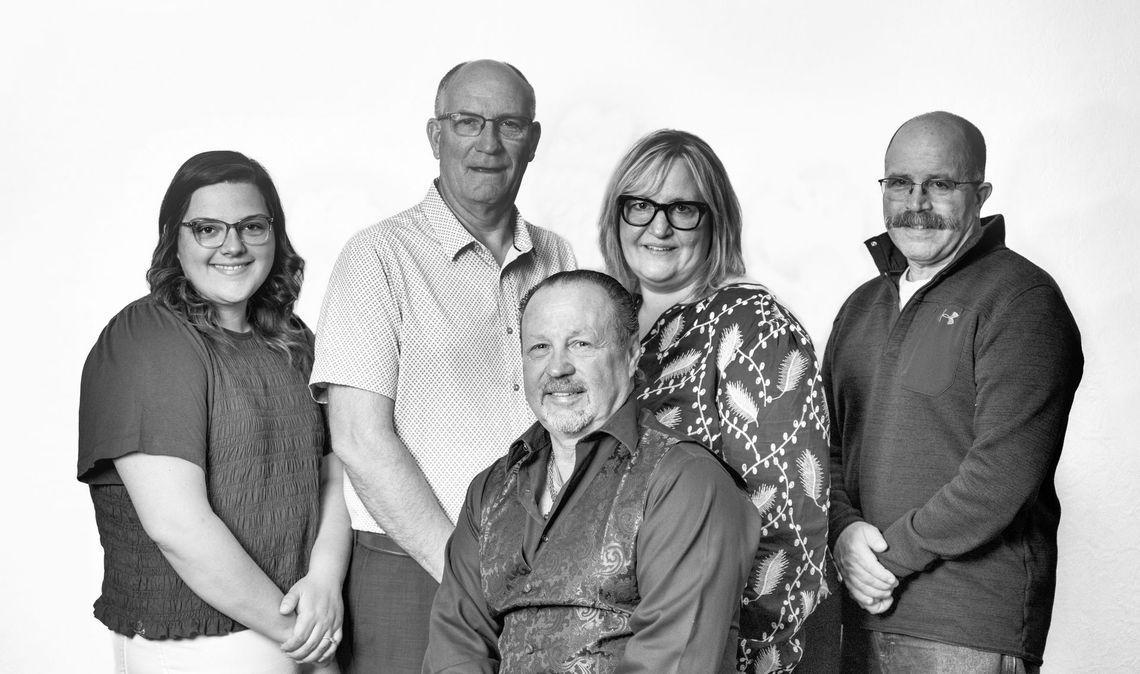 A group of people are posing for a picture together in a black and white photo.