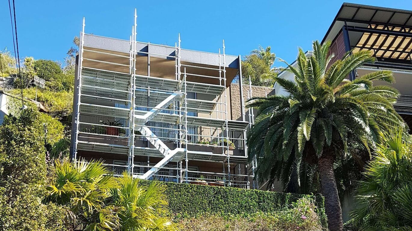 Residential scaffold hire for a luxury, multi-story house in Sydney's eastern suburbs, surrounded by greenery and palm trees