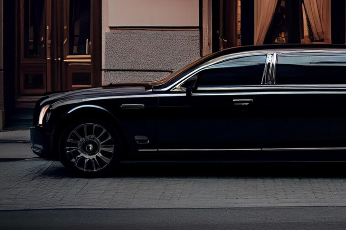 Luxury car parked in front of a grand hotel entrance

