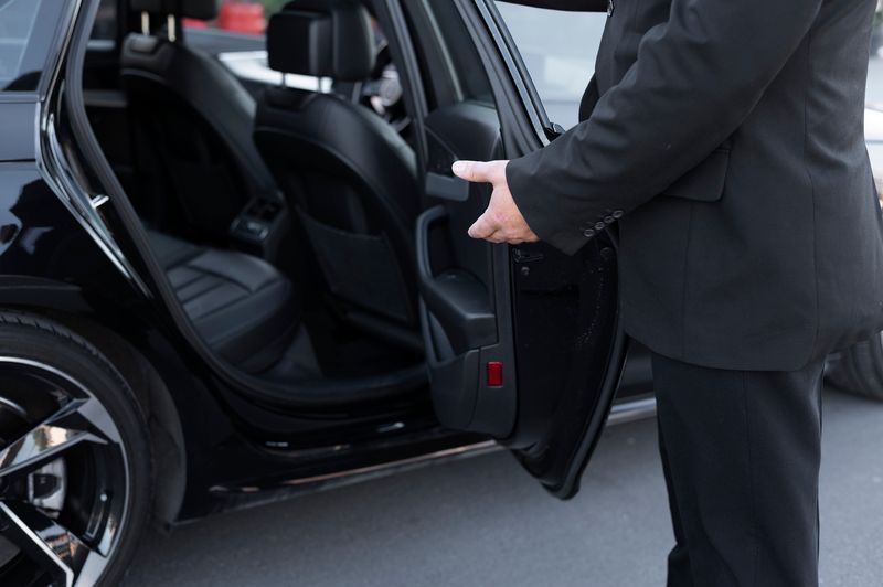 A man opening the car door.