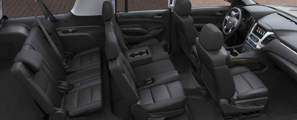 The interior of a gmc yukon is shown in black leather.