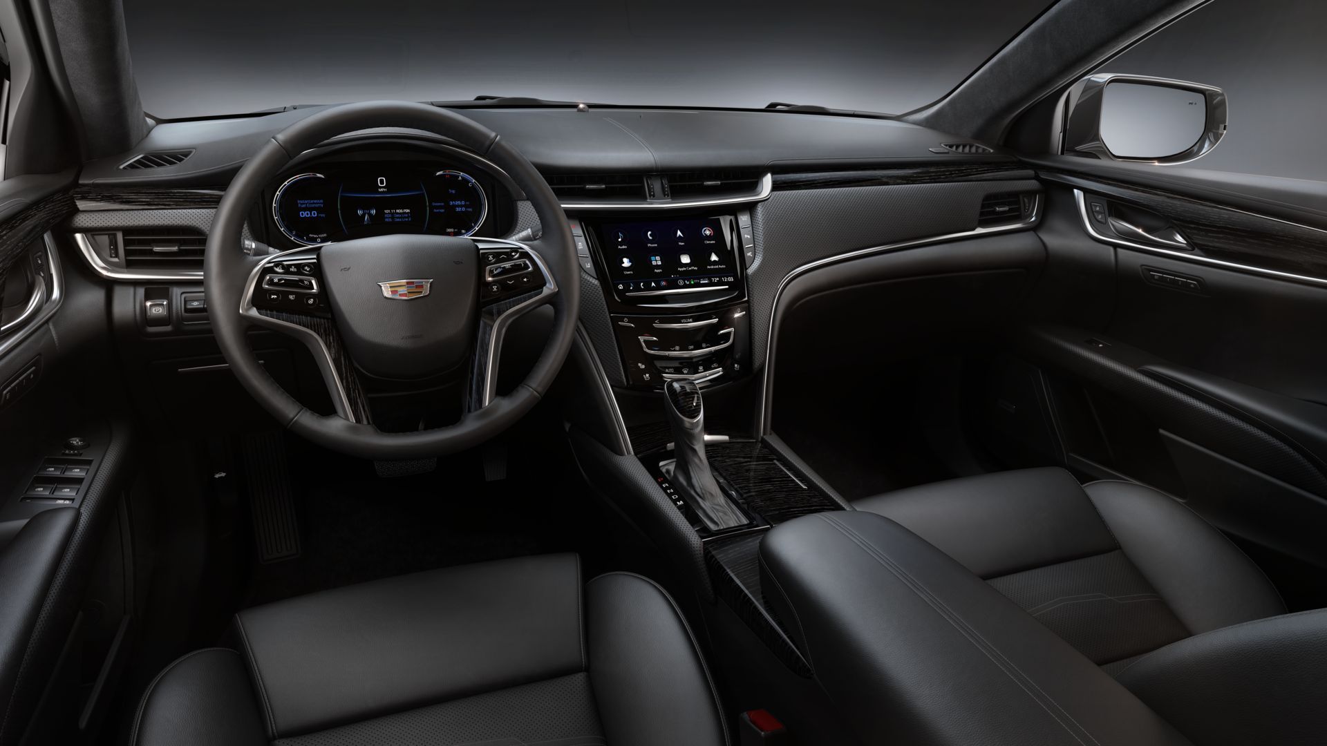 The interior of a car with black leather seats and a steering wheel.