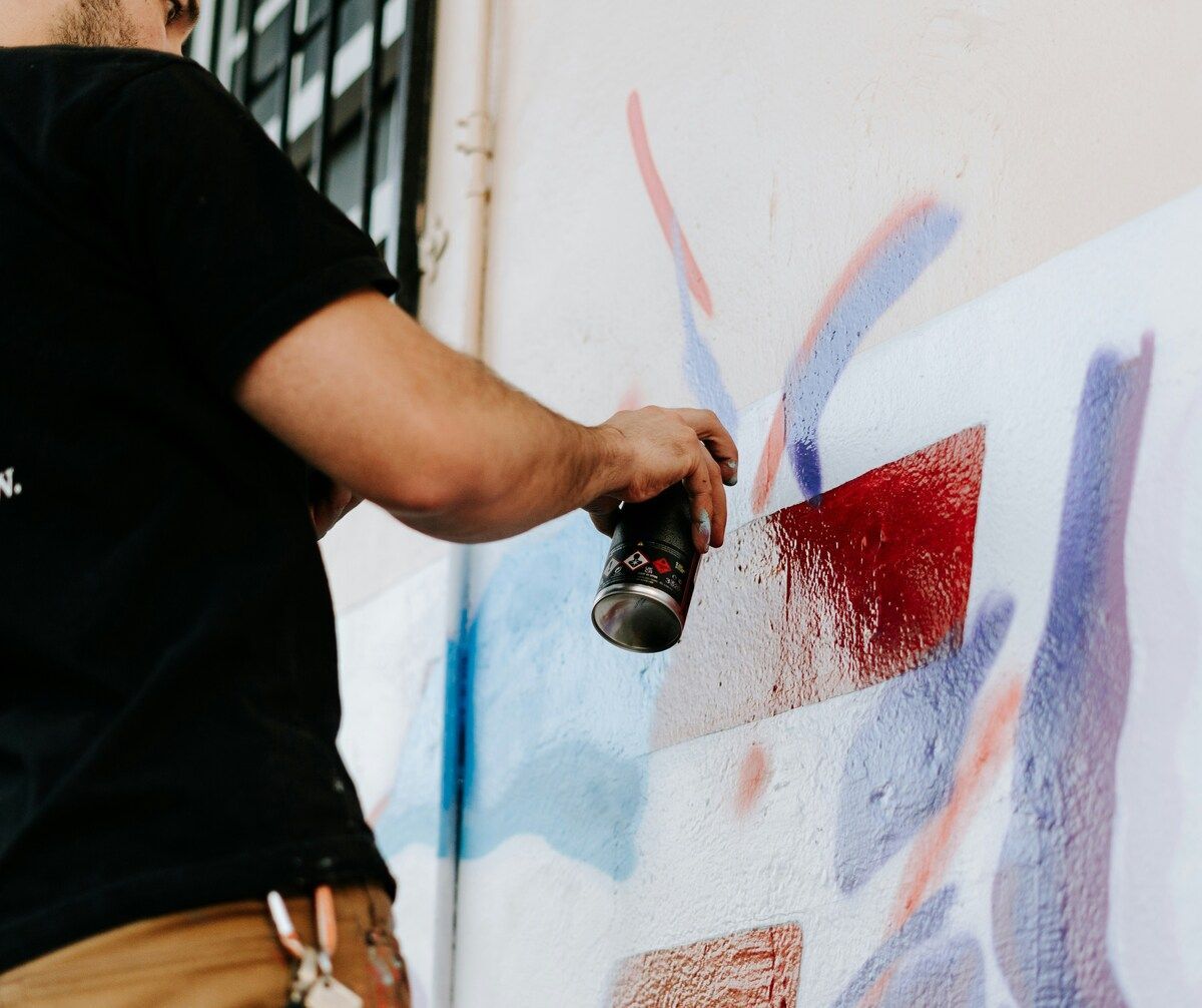 A person painting on a wall