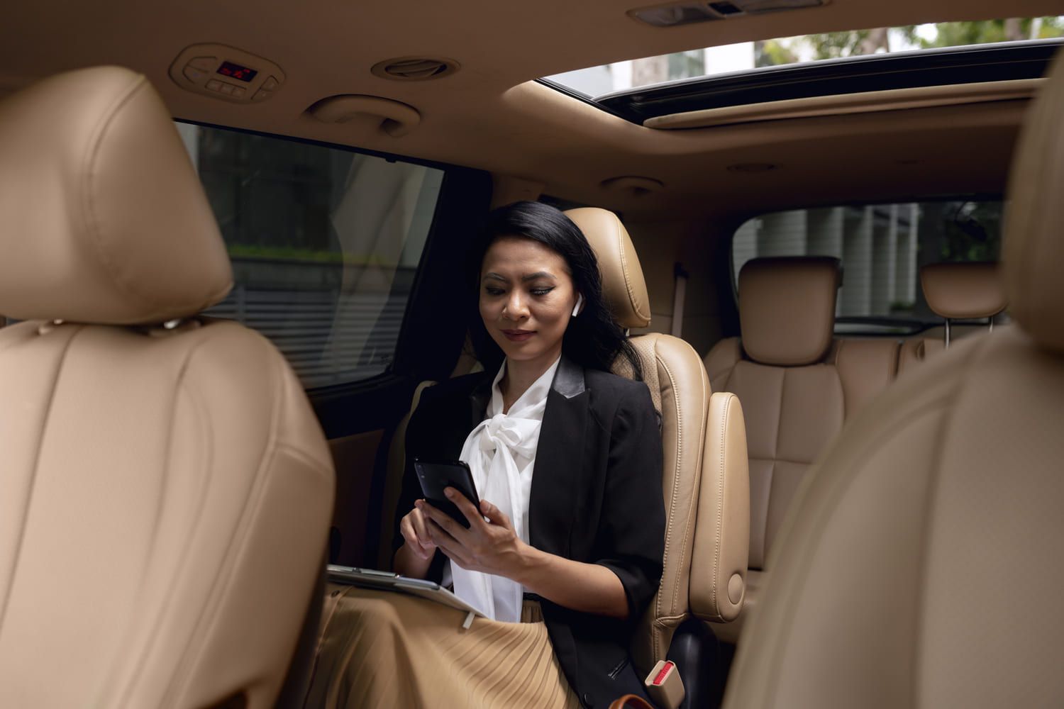 A woman is in a luxury car service vehicle