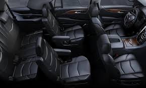 The interior of a car with black leather seats and a steering wheel.